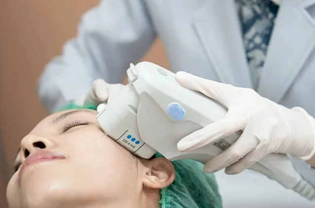 Facial treatment with medical device in clinic.